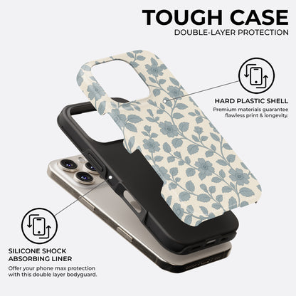 Exploded view of blue floral and leaf pattern iPhone tough case on cream background, showing hard plastic shell and silicone shock absorbing liner for double-layer protection by HaloCovers