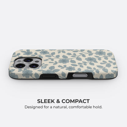 Slim and compact blue floral and leaf pattern iPhone tough case on cream background with sleek profile for a comfortable hold by HaloCovers